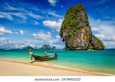 Thailand tropical vacation concept background - Long tail boat on tropical beach with limestone rock, Krabi, Thailand - Powered by Shutterstock