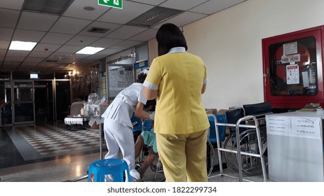 Thaksin Hospital,District Klongsan Bangkok,Thailand,26 September 2020,09.20 AM,Several Nurses Are Helping To Wound An Elderly Man On A Wheelchair,From Chronic Illness.