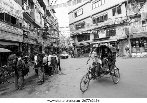 THAMEL,\
KATHMANDU, NEPAL - NOVEMBER 19, 2014: Rickshaws driving by the\
street of Kathmandu, Nepal on November 19. Rickshaws are the means\
of transport with the lowest cost in\
Kathmandu.