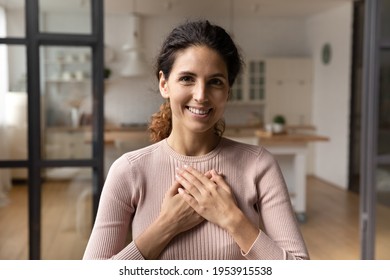 Thank you with all my heart. Portrait of grateful millennial latin woman hold hands on chest express sincere gratitude benevolence love. Touched young lady look at camera appreciate for kindness help