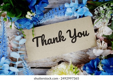 Thank you card with flower bouquet decoration top view on wooden background - Powered by Shutterstock