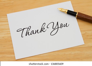 A thank you card with a fountain pen on a wooden desk, Writing a Thank You Note