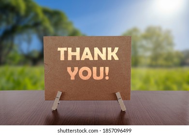 Thank You Card On The Table With Sunny Green Park Background.