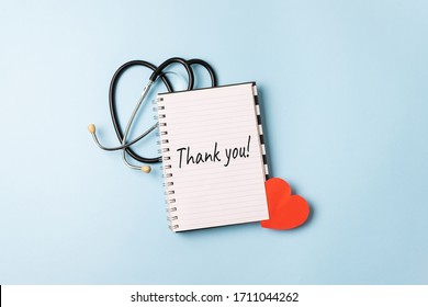 Thank You To Doctors, Nurses, Medical Workers. HAPPY NURSES DAY Background, Banner. International Nurses Day Healthcare And Medical Concept With Notebook, Red Heart And Stethoscope