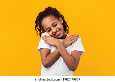 Thank You. Grateful Young Black Girl Holding And Pressing Hands To Her Chest Expressing Gratitude Posing Over Yellow Studio Background With Closed Eyes. Appreciation Concept - Powered by Shutterstock