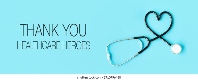 Thank you healthcare heroes message with stethoscope forming a heart on pastel blue background. Health and Covid-19 concept.
