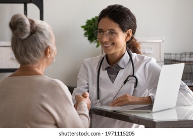 Thank You For Help. Grateful Aged Female Patient Shake Hand Of Smiling Young Woman Doctor Medic Gp Appreciate For Assistance. Thankful Mature Lady Handshaking Doc Therapist At Meeting In Clinic Office