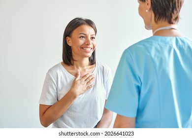 Thank You For Help. Happy Grateful African American Young Woman Patient Thanking Professional Female Doctor For Consultation, With Hand On Chest Saying Thanks To Doc During Healthcare Visit In Clinic