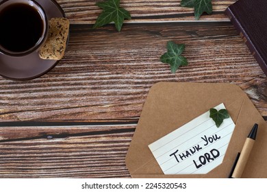 Thank You, LORD, handwriting on paper with envelope, pen, holy bible book, and cup of coffee on wooden background. Top view, copy space. Christian thanksgiving, gratitude, blessing, and praise to God. - Shutterstock ID 2245320543