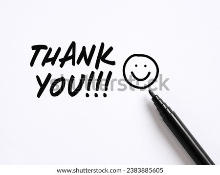 Thank you message with a hand drawn smiling emoticon face on white background. Gratitude concept.