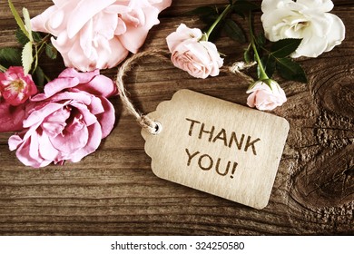 Thank You message with small roses on wood background - Shutterstock ID 324250580