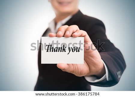 Thank you message word on card in hand of Friendly man hand and smiling