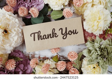 Thank You text message on paper card with flowers border frame on wooden background - Powered by Shutterstock
