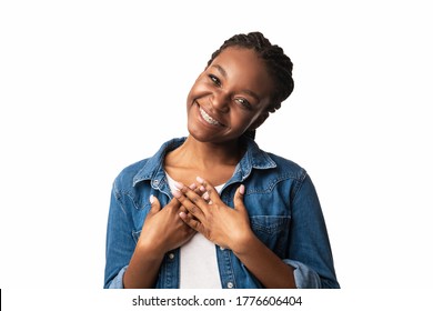 Thank You. Thankful African American Woman Pressing Hands To Chest Smiling To Camera Posing Over White Studio Background.