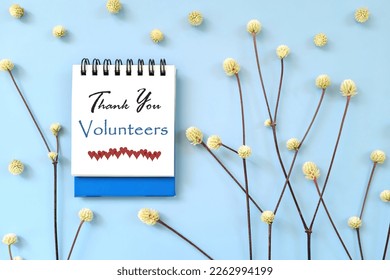 Thank You Volunteers message on blue notepad card with minimalist natural design. - Powered by Shutterstock