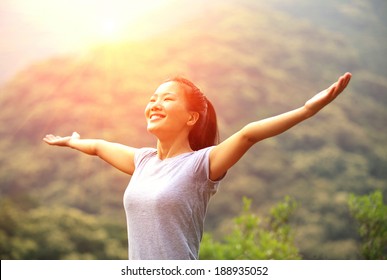 Thankful Woman Open Arms To The Sunrise Stand At Mountain Peak