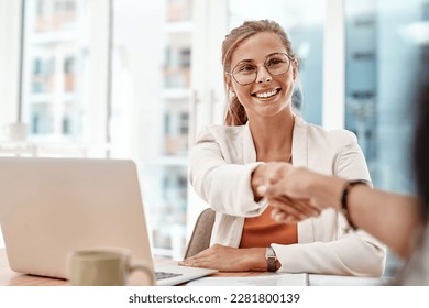 Thanks for joining. an attractive young businesswoman shaking hands with an unrecognizable colleague during a meeting in the boardroom.