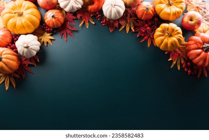 Thanksgiving and Autumn decoration concept made from autumn leaves and pumpkin on dark background. Flat lay, top view with copy space. - Powered by Shutterstock