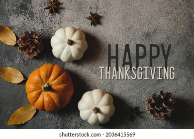 Thanksgiving background for autumn season holiday, top view of pumpkins and pinecones.