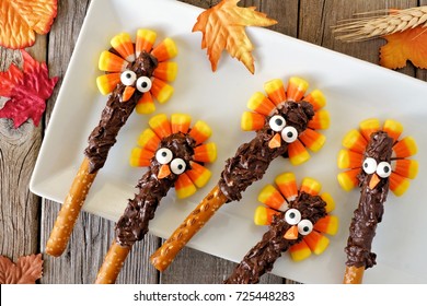 Thanksgiving Candy Corn Turkey Pretzel Rods On A White Plate, Overhead Scene