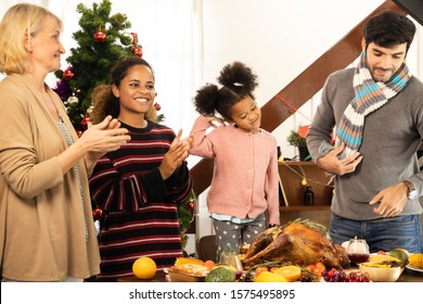Thanksgiving Celebration Tradition Family Dinner Concept.family having holiday dinner and cutting turkey.Young black adult woman and her daughter happy. - Shutterstock ID 1575495895