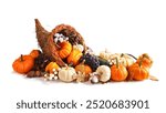 Thanksgiving cornucopia filled with autumn vegetables, pumpkins and fall decor isolated on a white background
