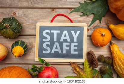 Thanksgiving COVID 19 Days. STAY SAFE Message  And Thanksgiving Flatlay On Wooden Background. Coronavirus Protection