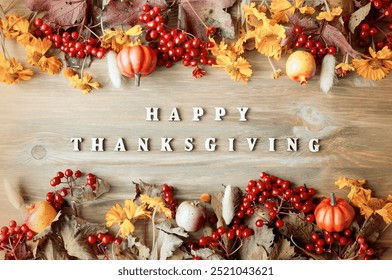 Thanksgiving day autumn background with Happy Thanksgiving letters, seasonal autumn nature berries, pumpkins, apples and flowers on the wooden background, Thanksgiving day card - Powered by Shutterstock