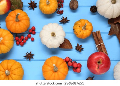 Thanksgiving day. Flat lay composition with pumpkins on light blue wooden table - Shutterstock ID 2368687651