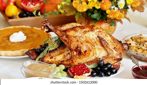 Thanksgiving Day. The Traditional Dishes For Thanksgiving. Young Turkey, Cranberry Sauce, Pumpkin Pie, Stuffing, Gravy, Mashed Potatoes, Green Beans, Pumpkin Muffins.