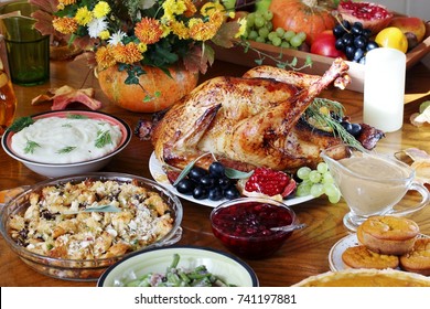 Thanksgiving Day. The Traditional Dishes For Thanksgiving. Young Turkey, Cranberry Sauce, Pumpkin Pie, Stuffing, Gravy, Mashed Potatoes, Green Beans, Pumpkin Muffins.