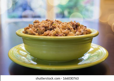 Thanksgiving Day Turkey Stuffing With Corn Bread Celery Cranberry In Green Bowl On Wood Table With Blurred Bokeh Lights