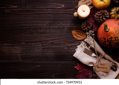 Thanksgiving Decoration With Cutlery And Napkin On The Wooden Table, Top View. Copy Space.