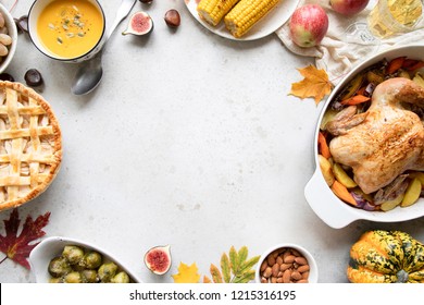 Thanksgiving dinner with chicken, apple pie, pumpkin soup brussel sprouts and fruits. Traditional autumn food concept. Flat lay. 