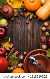Thanksgiving dinner place setting. Autumn fruit, pumpkins, nuts, fallen leaves with plate and cutlery. Thanksgiving autumn background