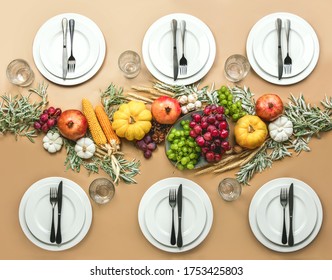 Thanksgiving Dinner Table Setting Decorated With Autumn Harvest Stuff And Greenery, Top Down View