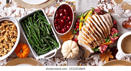 Thanksgiving Dinner Table With Sliced Turkey And Sides, Overhead Shot