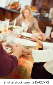 Thanksgiving: Family Praying Before Holiday Dinner