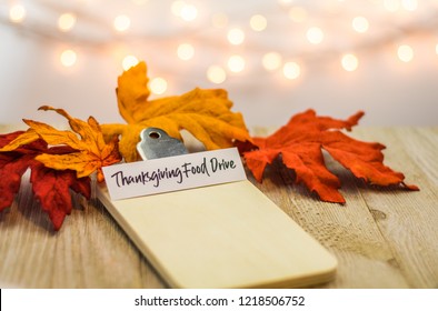 Thanksgiving Food Drive List Concept On Blank Clipboard Surrounded With Bright Leaves And Decorative Items Soft Background