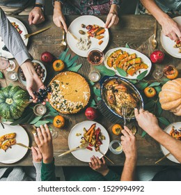 Thanksgiving, Friendsgiving Holiday Celebration. Flat-lay Of Friends Eating Meals At Thanksgiving Day Table With Turkey, Pumpkin Pie, Roasted Vegetables, Fruit, Rose Wine, Top View, Square Crop