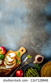 Thanksgiving Holiday Table With Traditional Festive Food - Turkey, Pumpkin Pie, Pumpkins, Green Beans, Cranberry Sauce, Corn, Autumn Apples, Dark Rusty Table, Top View Space For Text