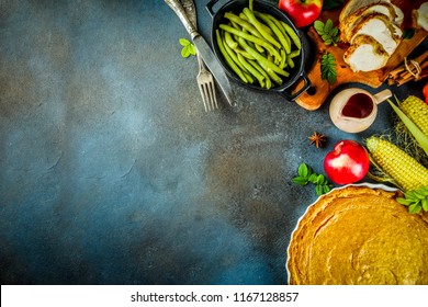 Thanksgiving Holiday Table With Traditional Festive Food - Turkey, Pumpkin Pie, Pumpkins, Green Beans, Cranberry Sauce, Corn, Autumn Apples, Dark Rusty Table, Top View Space For Text