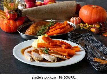 Thanksgiving Leftover Meal With Sliced Turkey Breast, Gravy, Mashed Potatoes And Carrots