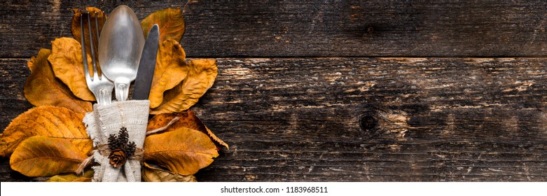 Thanksgiving Meal Setting Banner. Seasonal Table Setting. Thanksgiving Autumn Place Setting With Cutlery And Arrangement Of Colorful Fall Leaves.