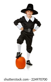 Thanksgiving: Pilgrim Boy Standing With Foot On Pumpkin
