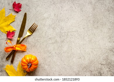 Thanksgiving Place Setting With Cutlery And Autumn Leaves, Top View