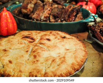 Thanksgiving Spread On Table Of A Pie, Meat And Decoration.