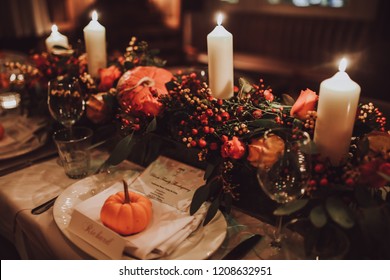 Thanksgiving Table Setting With Automnal Decorations, Pumpkins, Glasses And Plates. Holidays, Catering And Hospitality Concept.