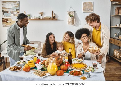 Thanksgiving traditions, multicultural friends and family gathering at festive table with turkey - Powered by Shutterstock