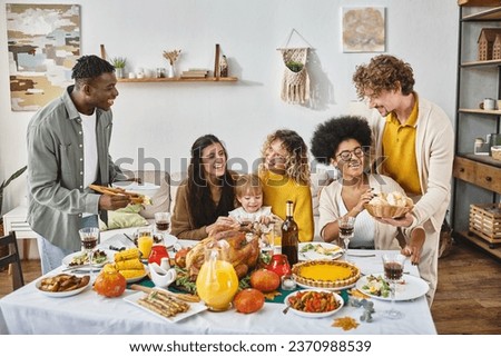 Thanksgiving traditions, multicultural friends and family gathering at festive table with turkey